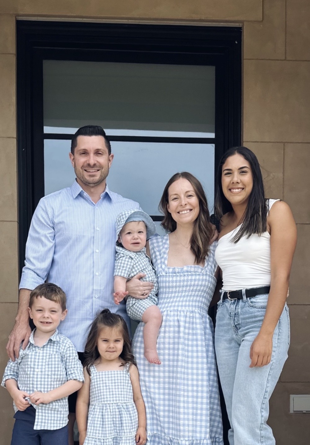 A host family with their au pair on the front steps